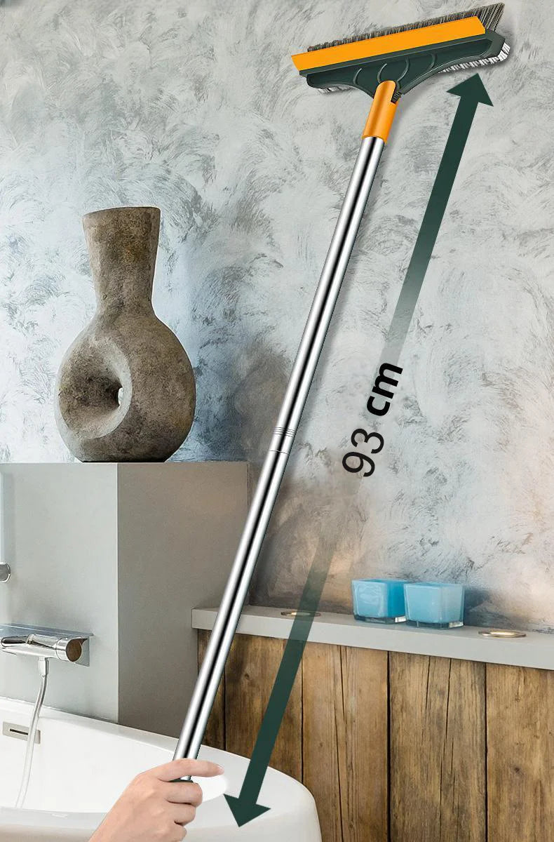 Langes Metallreinigungsbürste mit orangem Kopf neben Toilette und Waschbecken