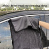 A dark gray multi-functional car cleaning cloth being used to wipe a car window.