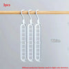Three white foldable plastic hangers hanging from a wooden rod.