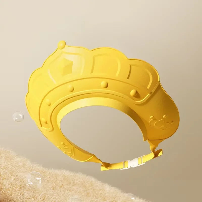 A yellow adjustable baby bath shampoo shield cap is shown against a light background.