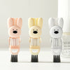 A set of three pink, beige, and white silicone cleaning brushes with bunny heads for portable cup and bottle cleaning.