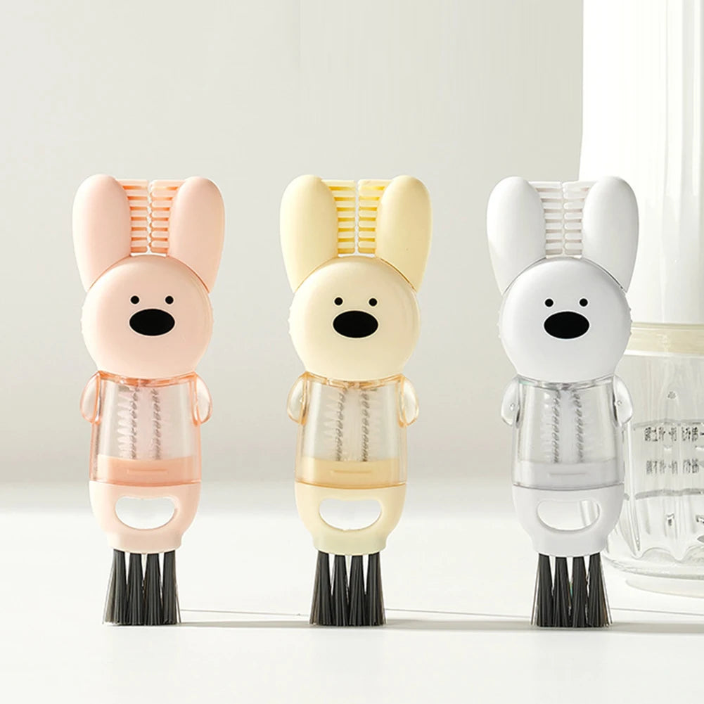 A set of three pink, beige, and white silicone cleaning brushes with bunny heads for portable cup and bottle cleaning.