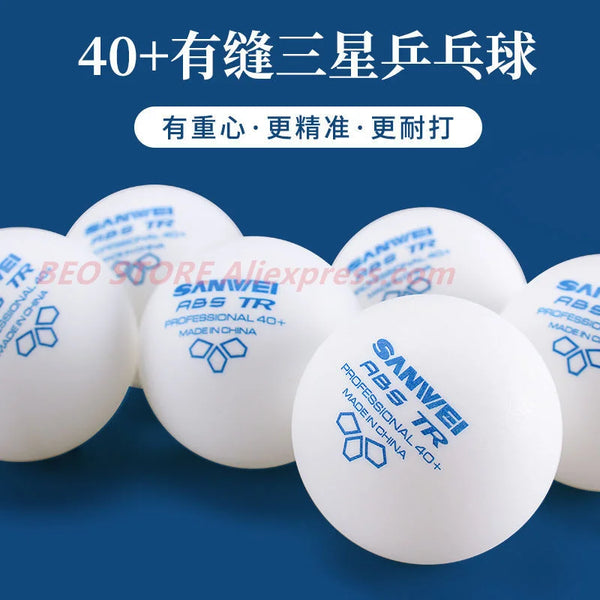 A close-up shot of multiple white Sanwei 40+ 3-star ABS table tennis balls on a blue surface.