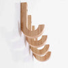 A vertical arrangement of natural oak wood wall hooks with screws.