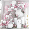 A pink and white balloon garland featuring heart shapes, glitter textures, and floral accents for a baby shower or celebratio