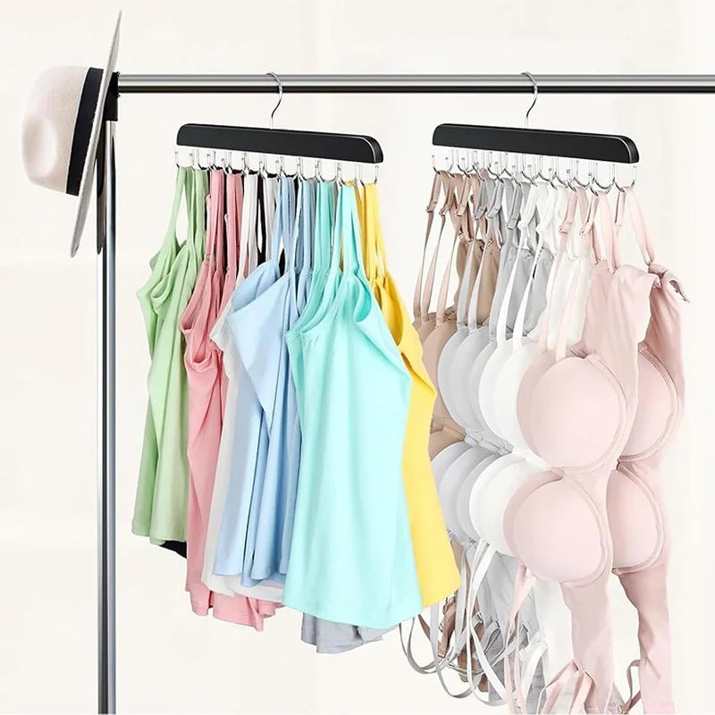 A rack of wooden belt and accessory hangers displaying various colored shirts and tops.