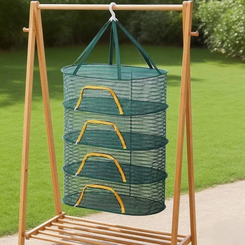 A portable folding drying rack made of wood is shown holding a green mesh basket filled with green produce.