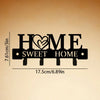 Black rustic metal wall hook key holder with the text HOME SWEET HOME engraved on it.