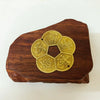 A wooden block with a carved design featuring traditional copper-style Chinese characters for prosperity.