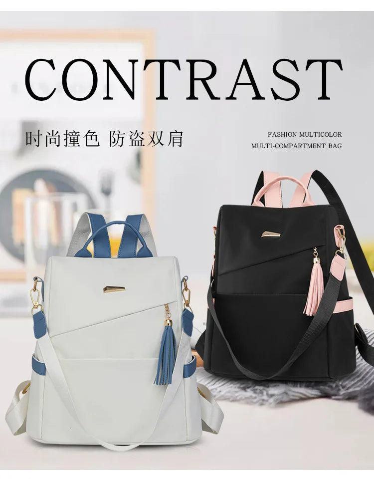 A light gray and blue multi-compartment backpack with pink accents shown against a white background.