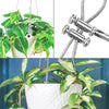 Close-up view of adjustable steel wire rope cable clamps used to suspend a potted houseplant.