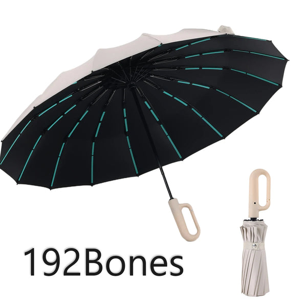 A black umbrella with a white canopy and teal accents is shown open against a white background.