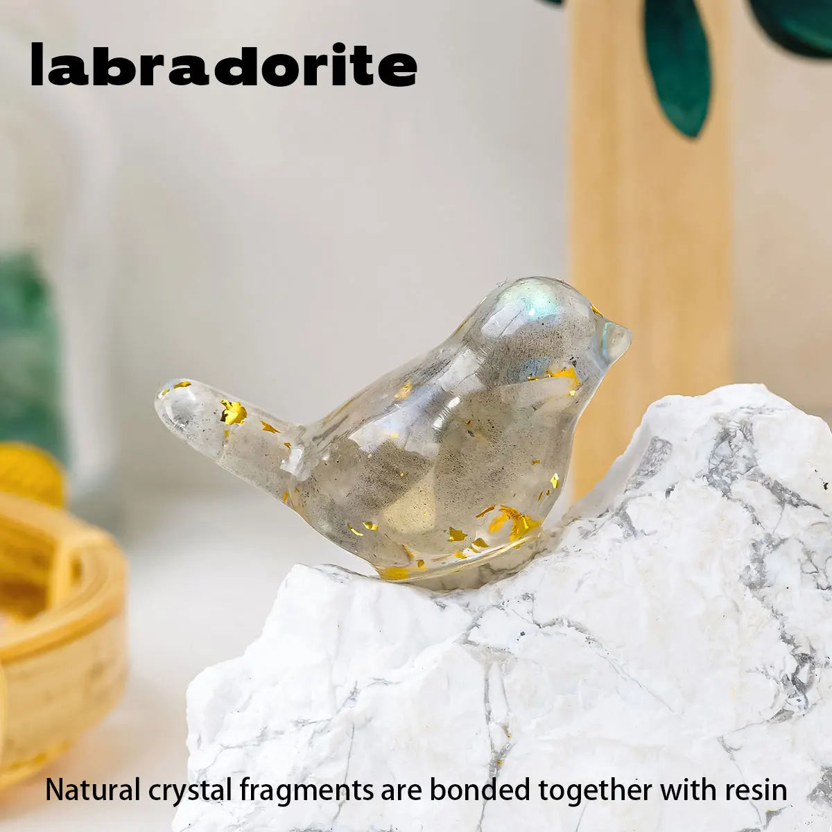A translucent silver crystal bird statue resting on a white marble surface.