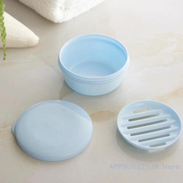 Light blue circular waterproof soap box with a matching drainage cover resting on a marble surface.