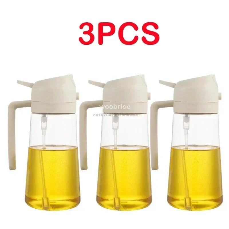 Three clear glass oil spray bottles with white pump tops filled with yellow cooking oil
