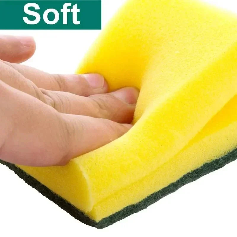A hand is holding a yellow soft cleaning sponge, demonstrating its texture and use.