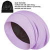 A rolled lavender satin sleep bonnet with a black lining is shown.