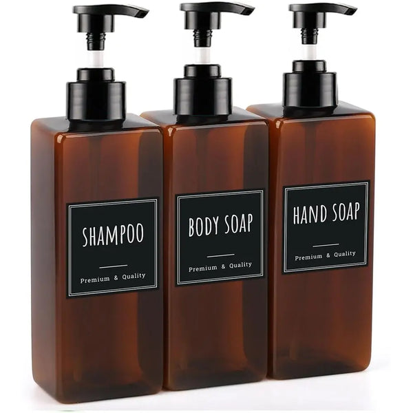 A set of three dark amber hand soap dispensers with black pump tops and labels for shampoo, body soap, and hand soap