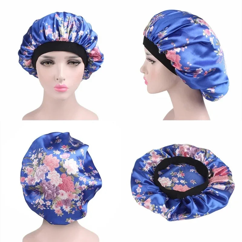 A satin sleep bonnet in blue with a floral pattern shown on a mannequin head and as a separate item.