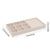 A rectangular velvet jewelry organizer tray with a soft lining, featuring multiple compartments.