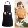 A black chef apron with a large front pocket is shown next to a woman preparing food.
