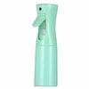 A light mint green refillable mist spray bottle with a hinged cap.