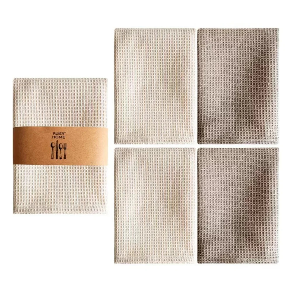 A set of four absorbent 100% cotton waffle weave towels in beige and brown tones.