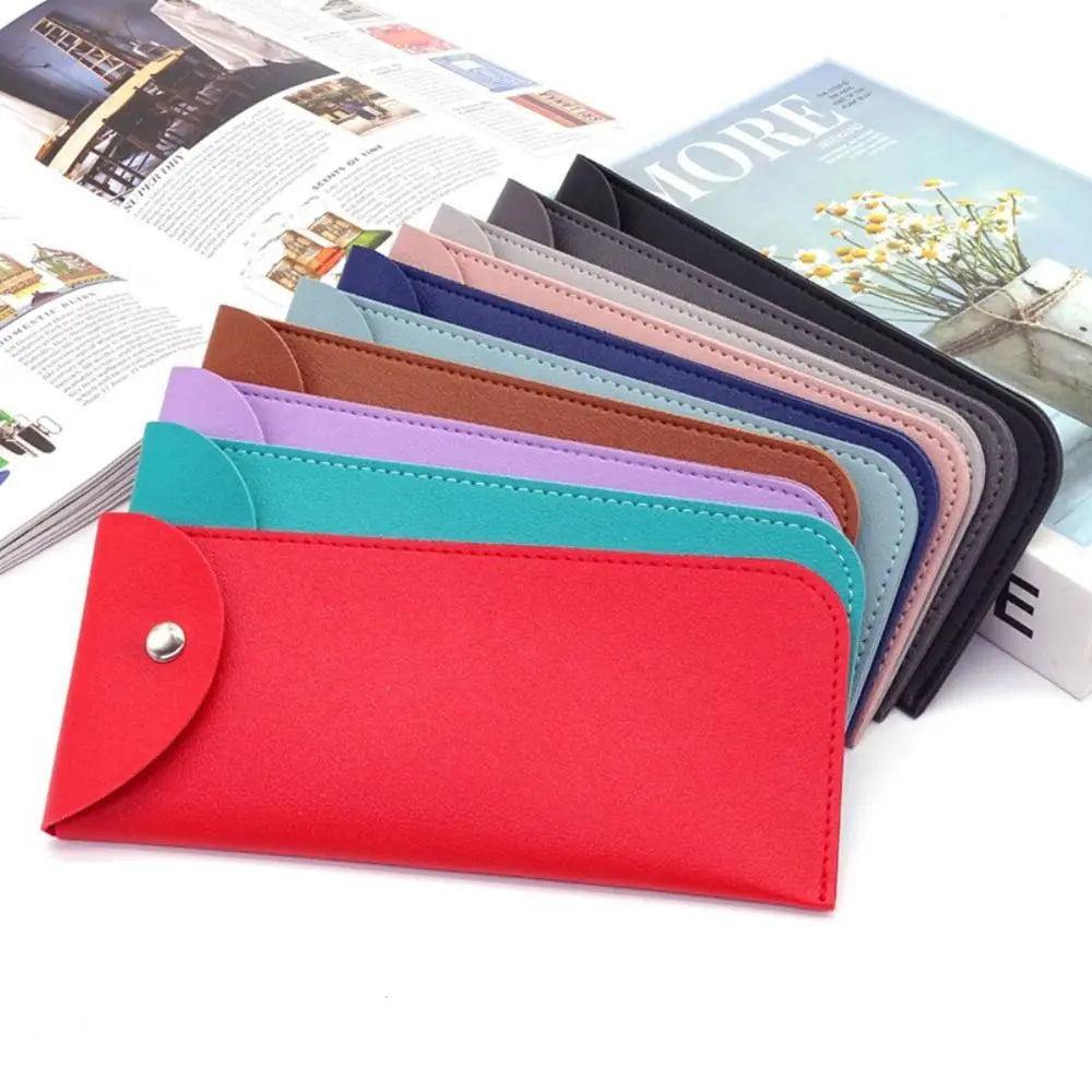 A stack of PU leather eyewear cases in various colors, including red, pink, blue, and purple.