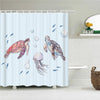 A watercolor illustration of sea turtles and fish on a light blue shower curtain.