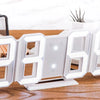 A white 3D LED digital alarm clock displaying the time 8869 on a wooden surface.