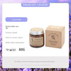 A brown aromatherapy soy wax candle in a glass jar with a label and an accompanying box.