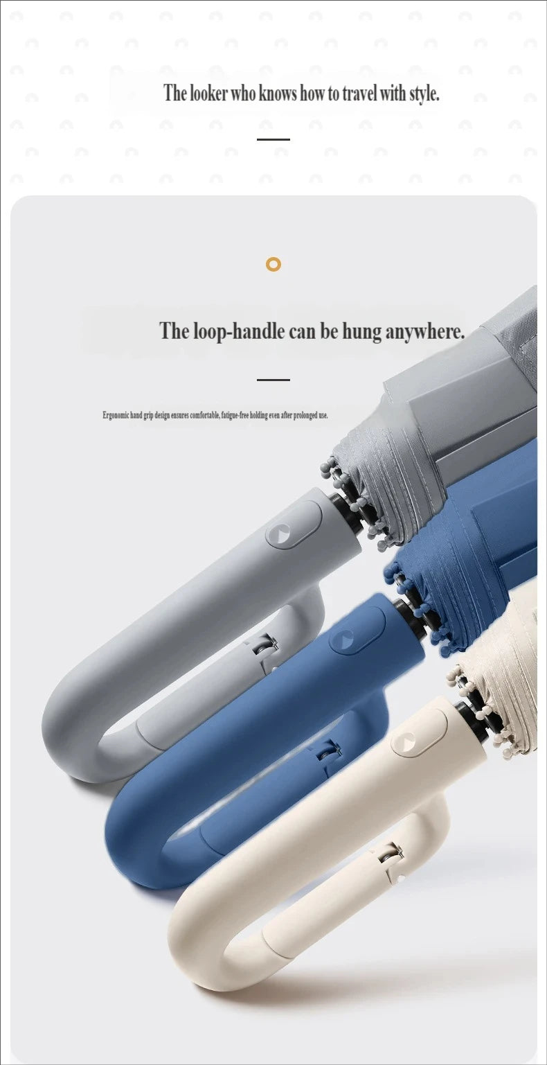 A close-up view of a large automatic folding umbrella in various colors, showing the loop handle design.