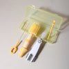 A silicone baby bottle cleaning set with a clear plastic case containing a brush and a cleaning tool.