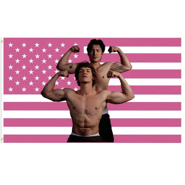 A muscular man is positioned in front of a pink American flag, with another man standing behind him.