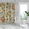 A beige and green floral print shower curtain featuring roses and foliage hanging in a bathroom.