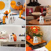 A collection of terrifying ghost statue decorations and orange Halloween themed decor.