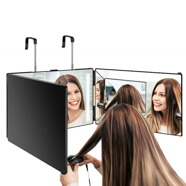 A person is using a 360-degree trifold haircut mirror with LED lighting to view their hair.