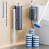 A wall-mounted disposable toilet brush and cleaning kit displayed next to a white toilet.