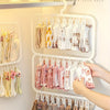 A white multi-layer sock rack displaying various colored and textured socks and laundry items hanging on hangers.
