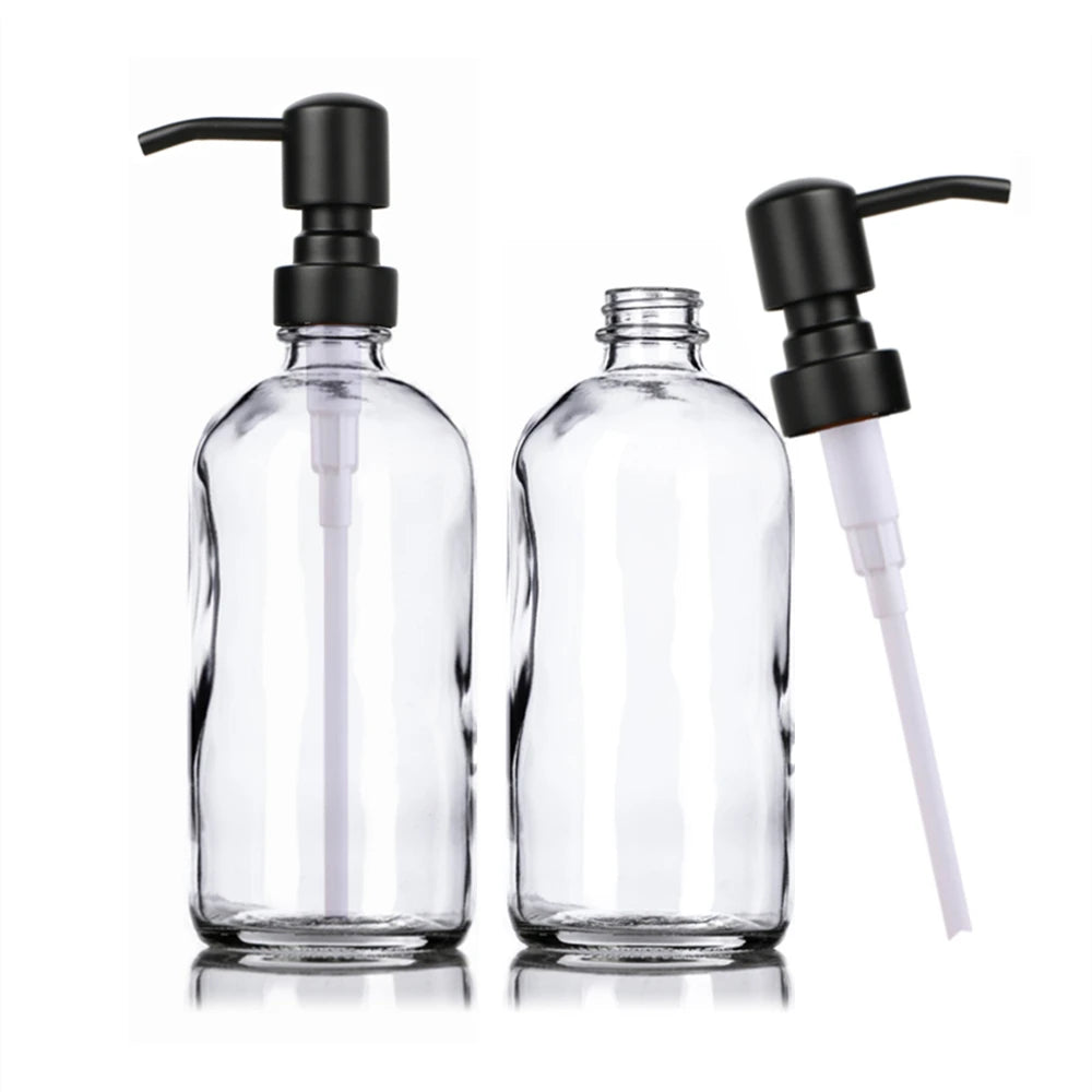 A clear glass soap dispenser set featuring a pump mechanism with black and white components.