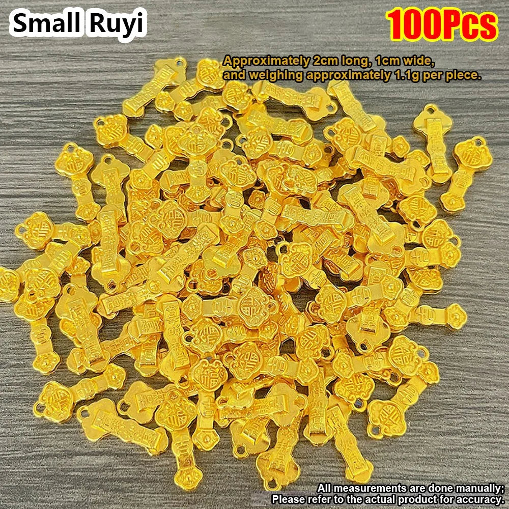 A pile of 100 small gold bar decorative ornaments, approximately 2cm long and 1cm wide.