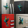 Magnetic articulated fidget frog in teal and green attached to various appliances.