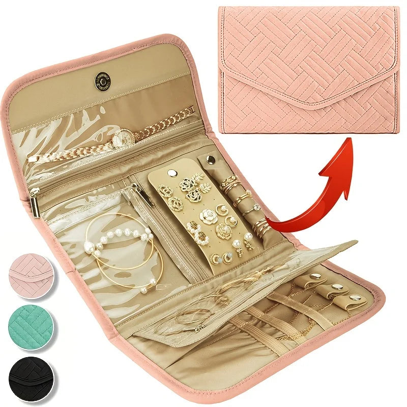 A pink foldable waterproof jewelry organizer bag open to display various gold and pearl necklaces and earrings.