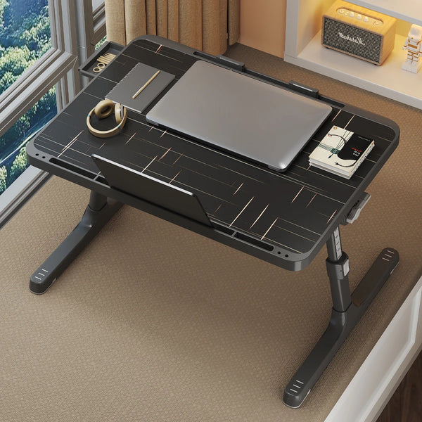 A gray adjustable wooden laptop tray and lapdesk is shown on a light-colored floor next to a window.