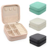 A set of portable PU leather jewelry storage boxes in pink, beige, and gray.