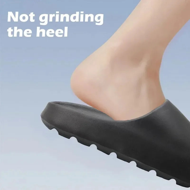 A close-up of a black EVA slide foot with a warning that it is not grinding the heel.