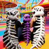 A costume set featuring realistic dinosaur skeletons in gray and purple colors standing in a colorful amusement park
