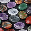 A collection of polished, oval natural quartz thumb stones in various colors including purple, green, and reddish-orange tone