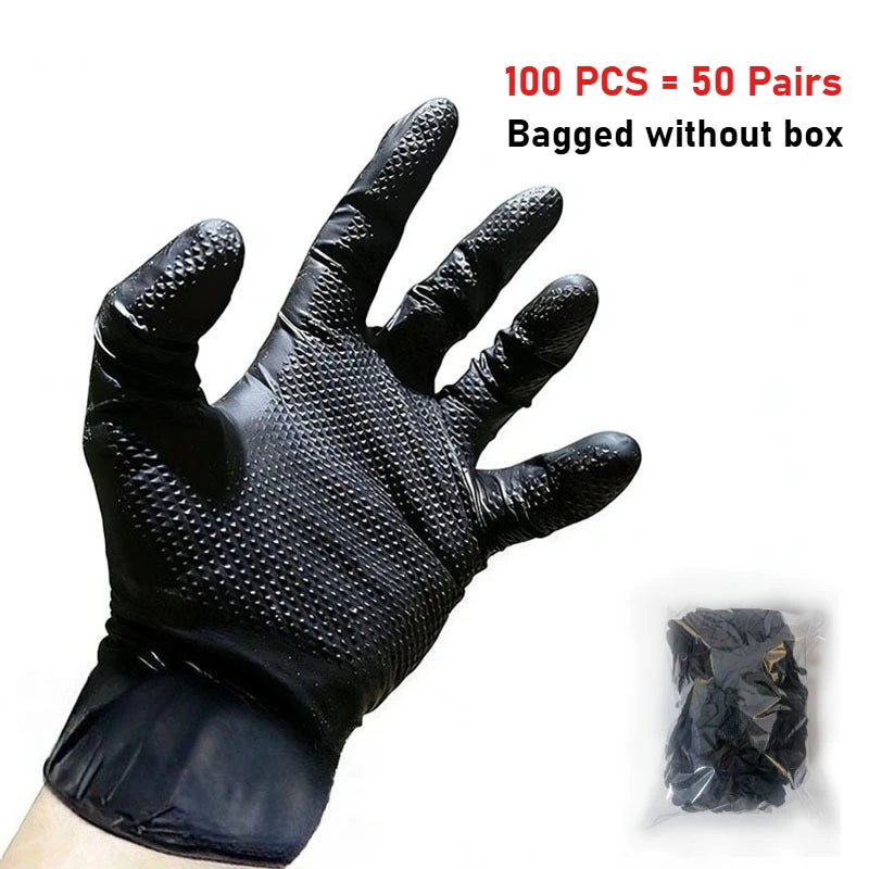 A hand wearing a black, extra thick heavy-duty disposable nitrile glove with a diamond texture is shown next to a packaged se