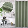 A solid sage green waterproof shower curtain hanging in a bathroom setting.